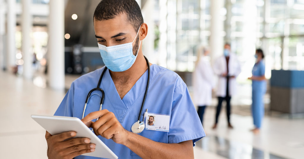 electronic medical records in nursing shown by a nurse holding an emr on a tablet