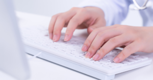 electronic medical records types being explored by hands typing on a keyboard
